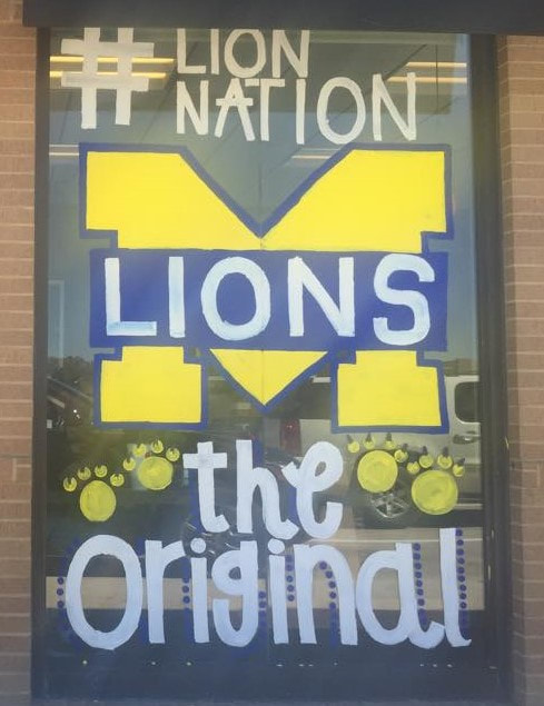 Lion Nation window painting with the MHS Lions logo